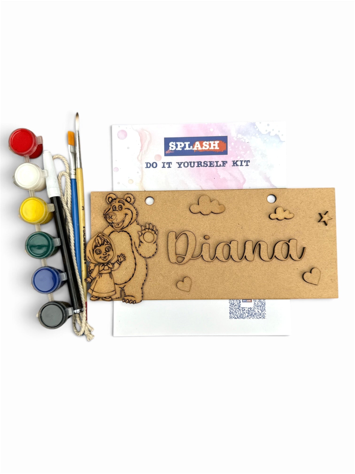 A DIY wooden engraving kit labeled 'SPLASH DO IT YOURSELF KIT' on a white background, featuring a natural wood plaque engraved with a bear, clouds, hearts, and the name 'Diana', alongside paint pots, brushes, and a paint palette.