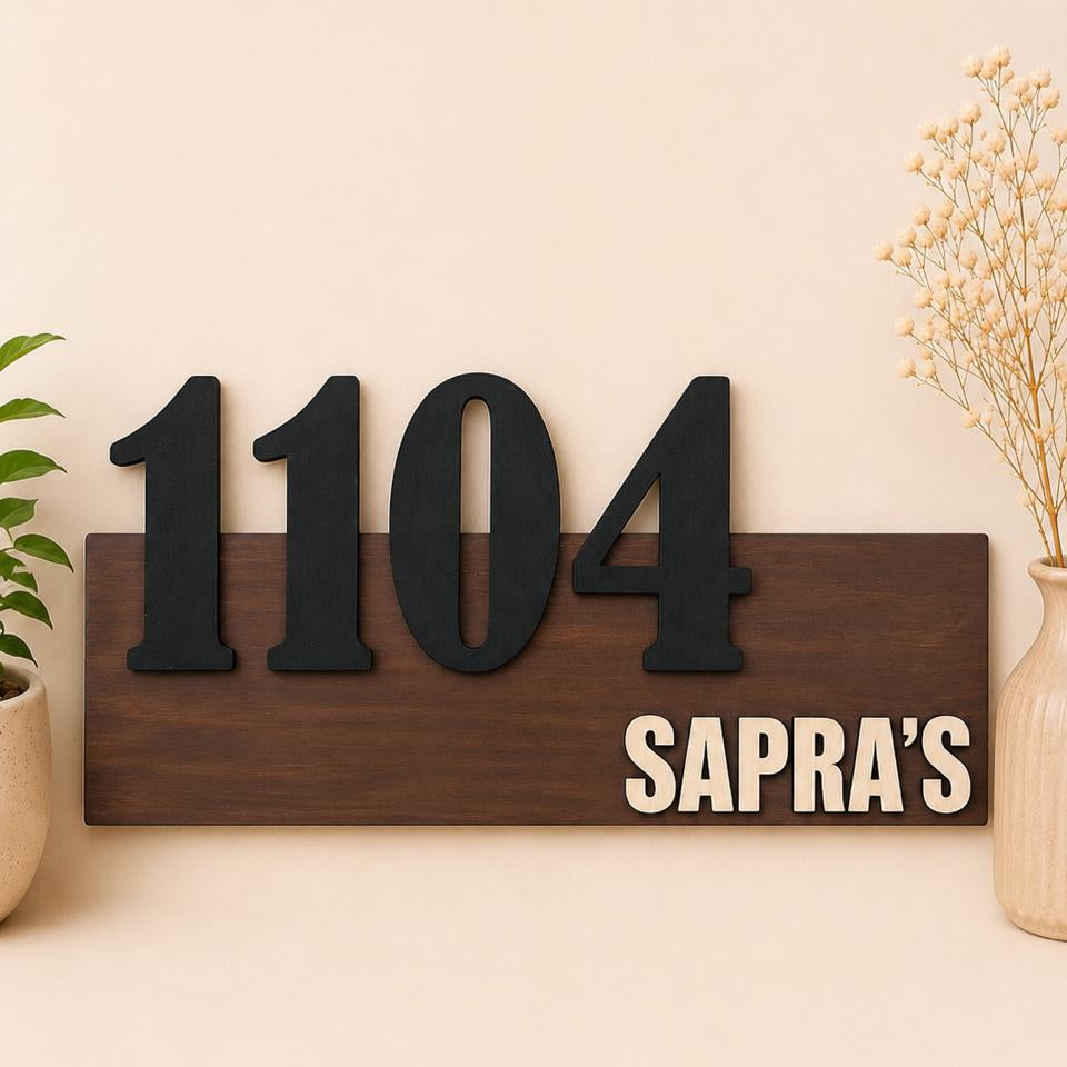 A rectangular dark wood house number sign with raised black numerals