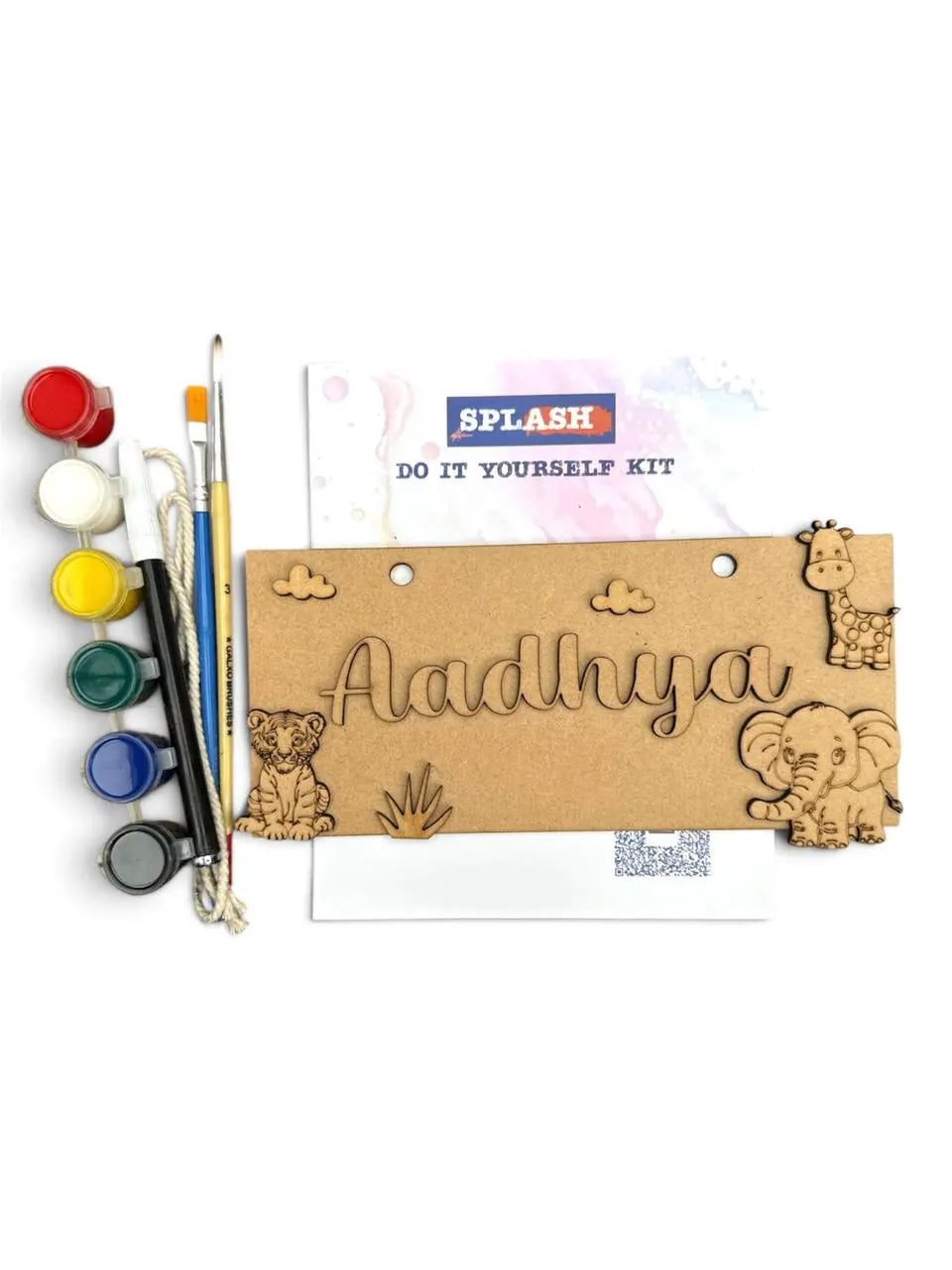 A personalized children's paint-by-numbers kit by Splash, featuring a laser-cut wooden nameplate engraved with 'Adhnya' and decorated with animal illustrations, alongside paint pots, brushes, and an instruction sheet on a white background.