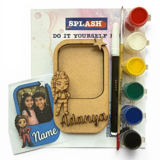 DIY photo frame kit with a wooden frame, paint palette, paintbrush, and sample photo card on a white background.