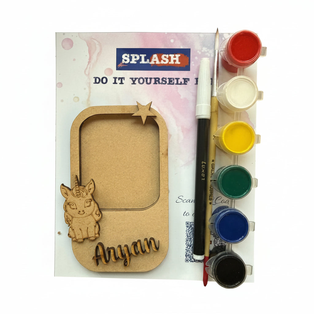 Personalized kids' DIY paint by numbers kit by Splash, featuring a wooden nameplate with a cartoon cat design and the name 'Anyan', a paint palette with six color wells, a paintbrush, and a paint pen on a white background.