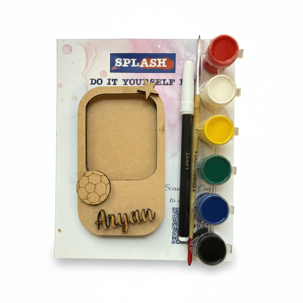Personalized laser-cut wooden name plaque kit with a soccer theme, shown with a paint palette, paint brush, and printed backing card on a white background.