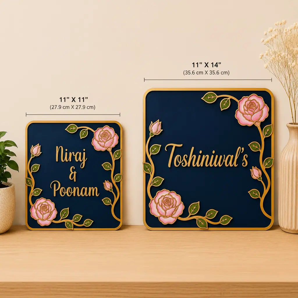 Two decorative nameplates with floral designs and measurements on a wooden surface.