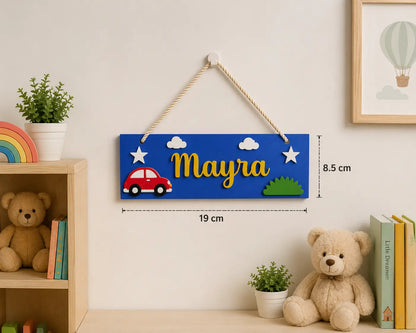 Children's nameplate with colorful design and measurement details, hanging on a wall with toys and decor.