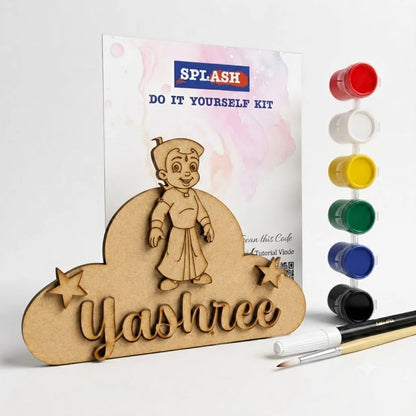 Personalized wooden craft kit featuring a laser-cut wooden stand shaped like a cloud with the name 'Yashree' and a cartoon character, shown with a printed instruction card, six small paint pots, and two paintbrushes on a white background.