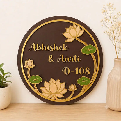 Decorative wall plaque with lotus designs and text on a wooden surface.