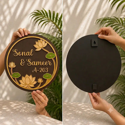 Two wooden circular signs with floral designs and engraved text, one with a decorative design and the other plain.