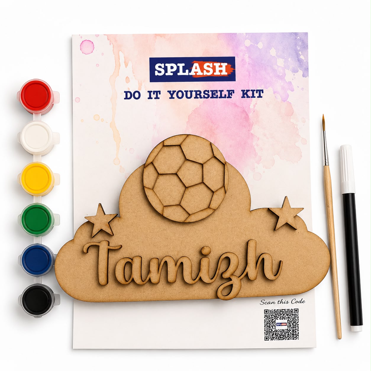 A DIY laser-cut wood kit labeled SPLASH, featuring a cloud-shaped wooden plaque with the name Tamizh, a soccer ball cutout, and two stars, shown with paint pots, a paintbrush, and a marker on a white background.