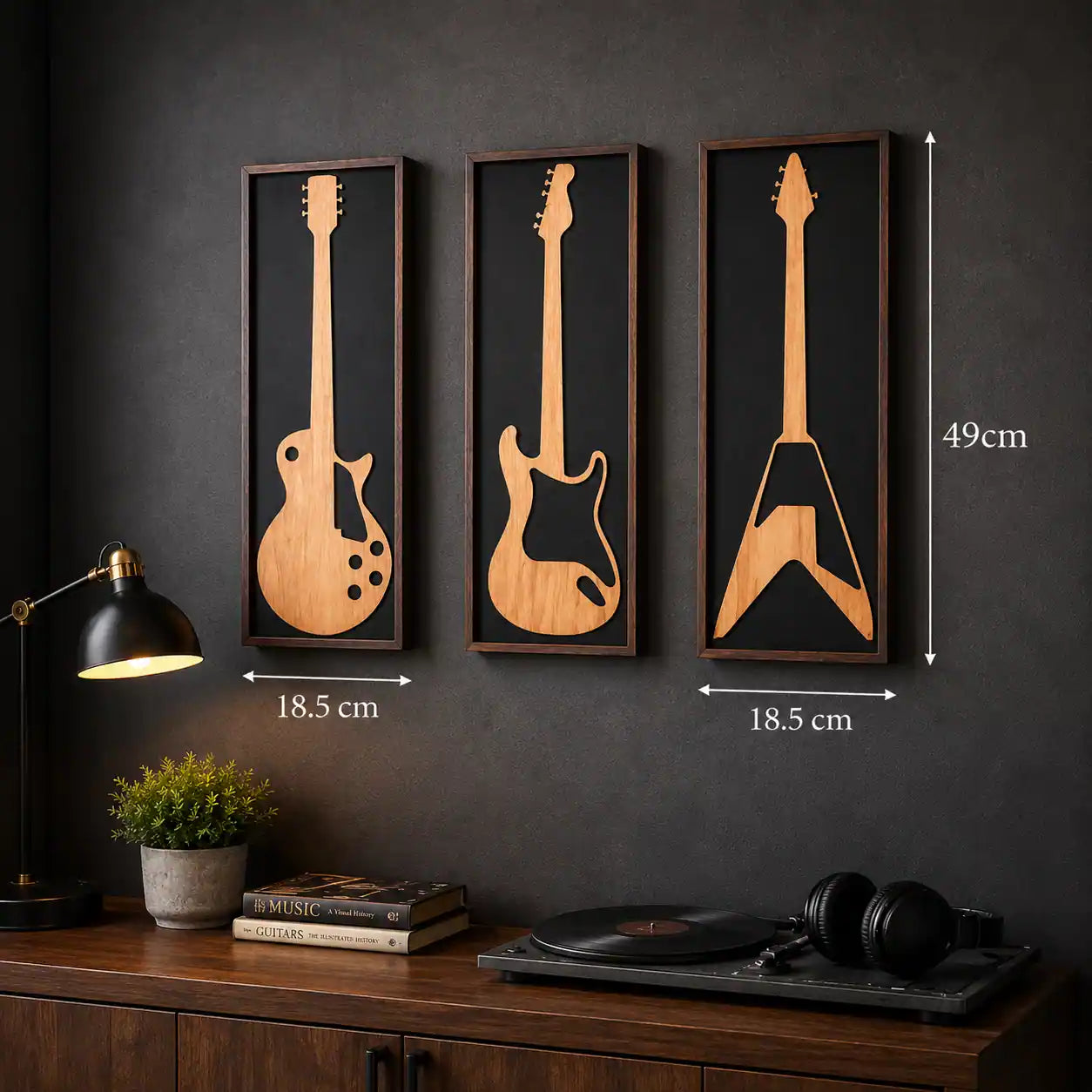 Three wooden guitar wall art pieces with dimensions on a dark wall.