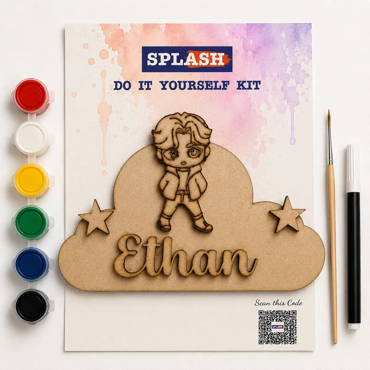 Personalized laser-cut wooden kit for kids by SPLASH, featuring a wooden character, stars, and the name 'Ethan' on a cloud-shaped piece, displayed with paint pots, a paintbrush, and a marker on a white background.
