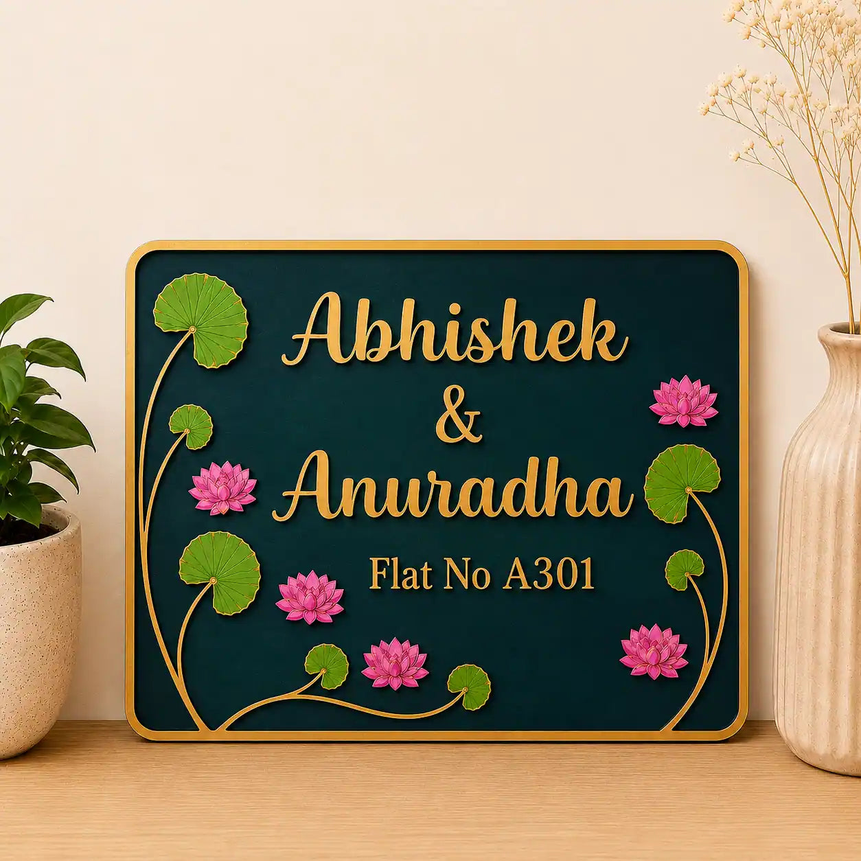Decorative nameplate with floral designs on a wooden surface